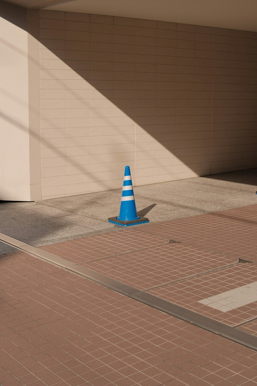 a blue cone on a brick floor