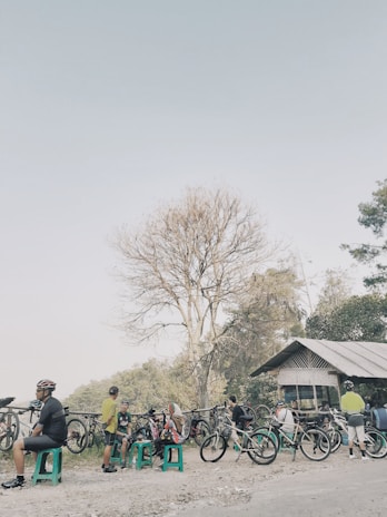 A group of riders pausing at a rustic roadside café, helmets off, sharing stories.