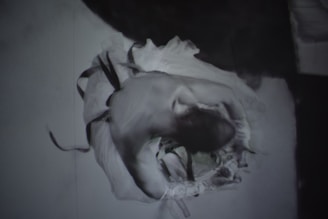 Dynamic black and white image showing fluid motion of a dancer in a minimalist space.