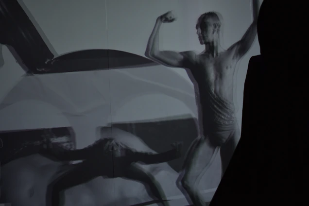 Black and white high-contrast photo of an athlete in motion, emphasizing strength and agility.