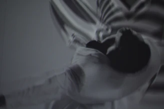 Athlete in motion with subtle violet DNA strands overlay.
