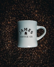 a white mug with a black label on a brown surface