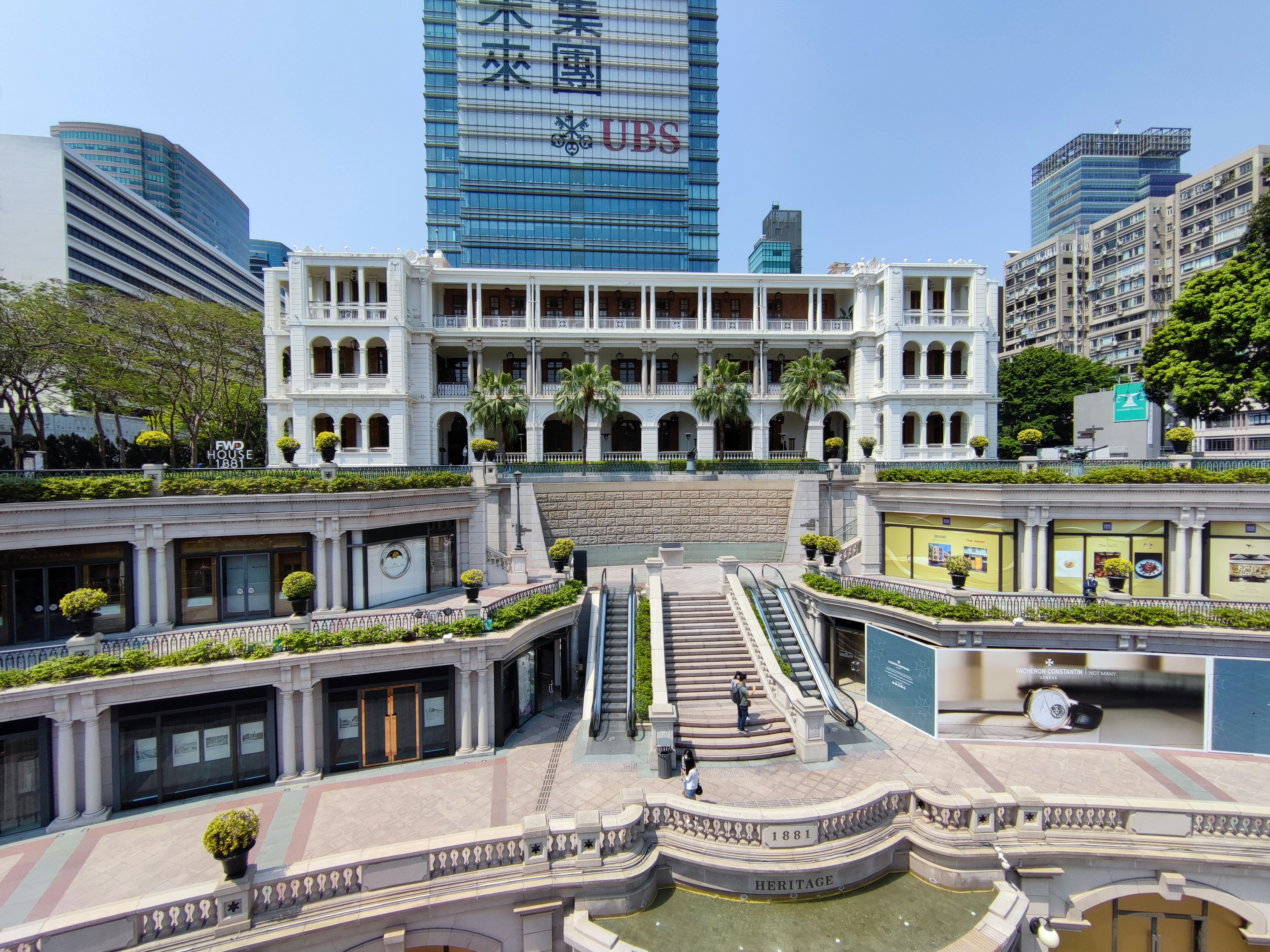 This is a historical preservation and rejuvenation project in Hong Kong called 1881 Heritage. The place was the 'Former H.K. Marine Police Headquarters' during the British colonial rule. The architectural style is Victorian Colonial Neo-classical style. The whole site including the Main Building and other facilities is now converted into a hotel called FWD House 1881 with French and Chinese cuisine restaurants, and a luxurious shopping centre which is called 1881 Heritage. The photo was taken on the Landscape Deck.