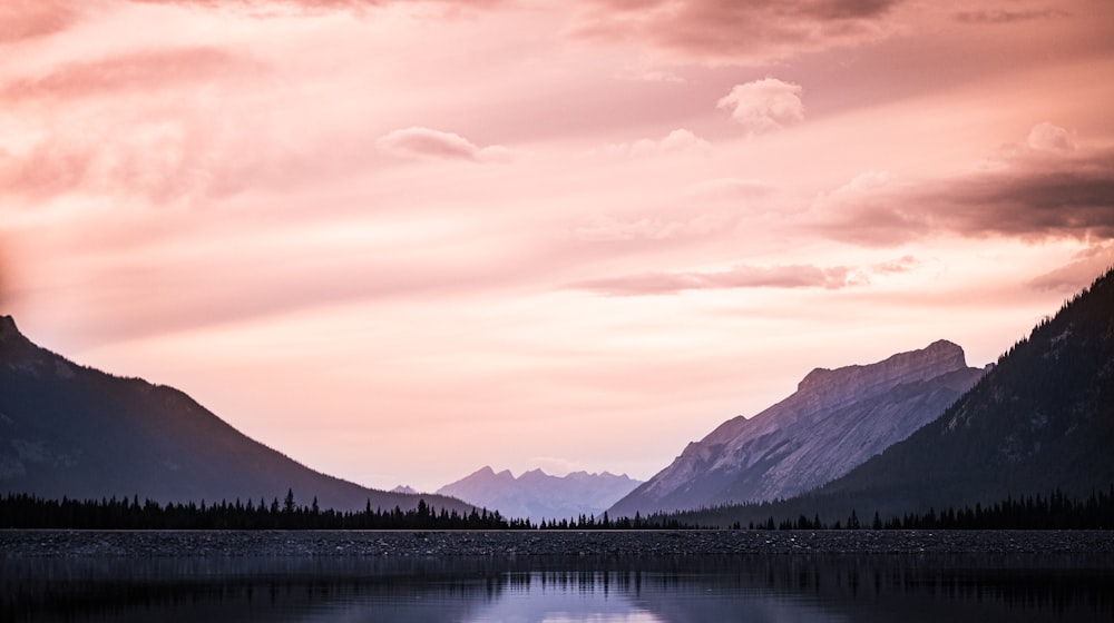 a body of water with mountains in the background