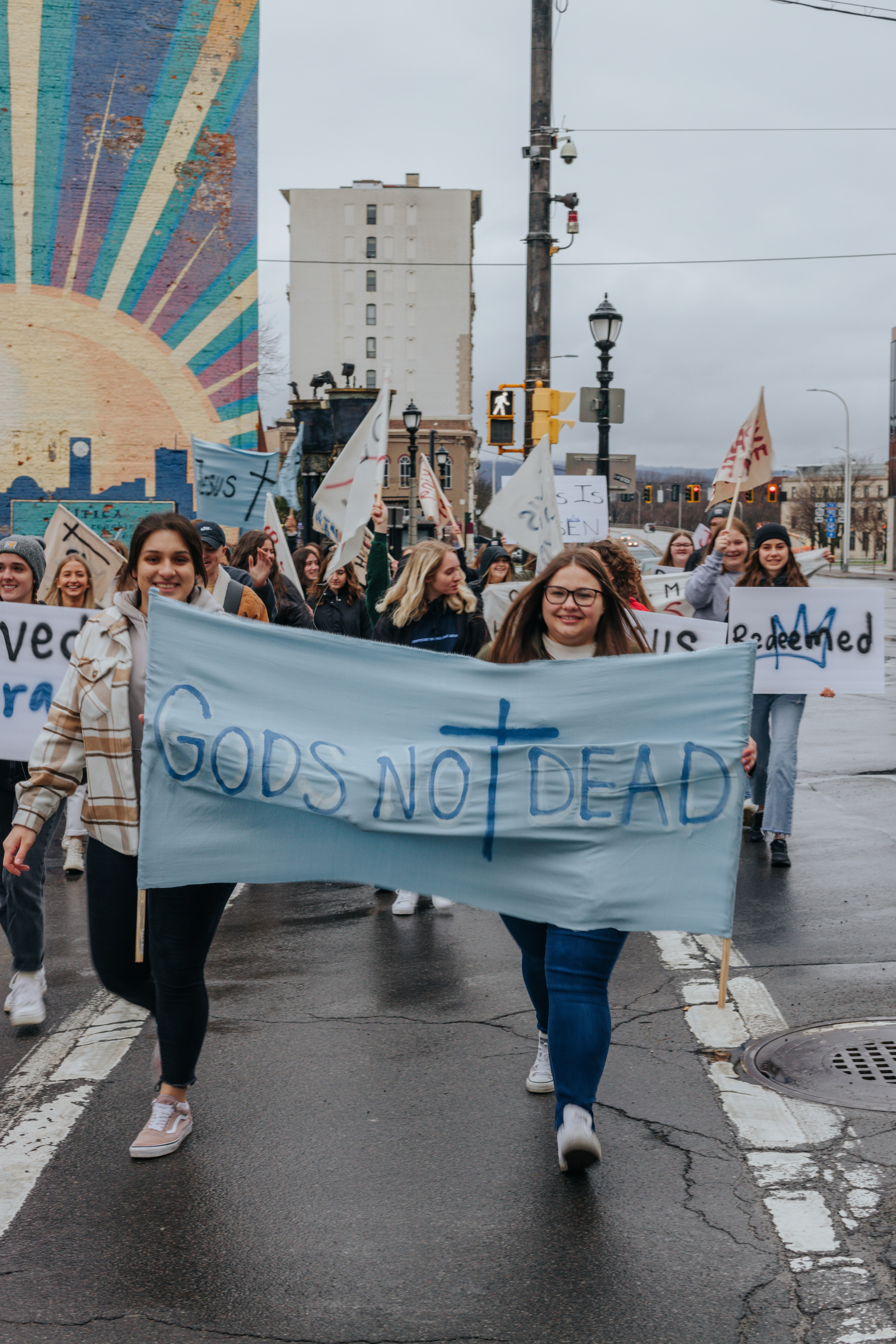 a group of people marching with a banner