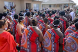 Community members gathering in traditional attire during a social event