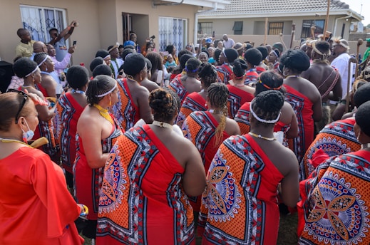 Diverse group of men and women showcasing various braided hairstyles outdoors.
