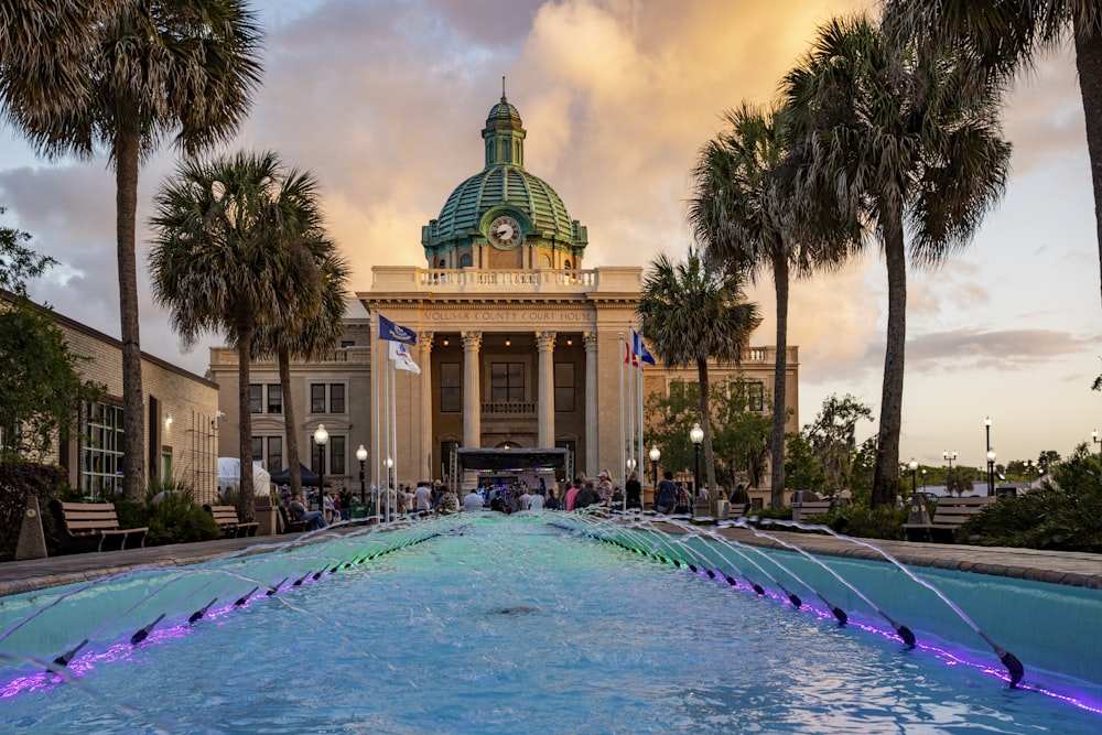 a large building with a pool in front of it