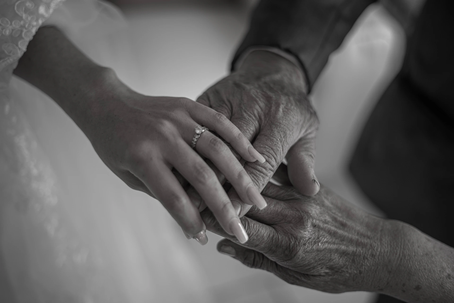 a close-up of a woman and a man holding hands