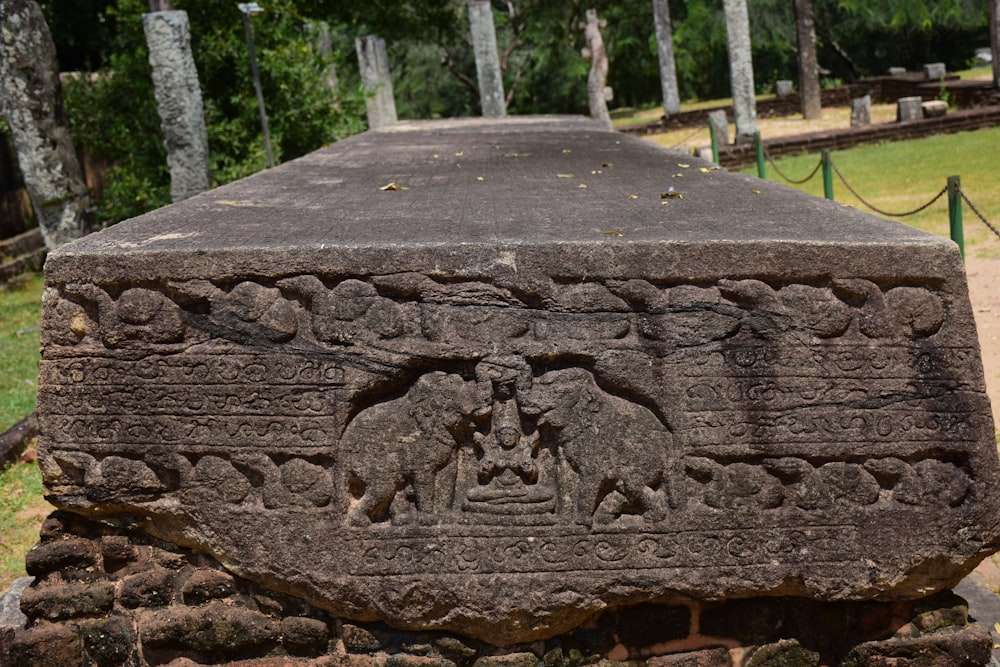 a tree stump with carvings on it