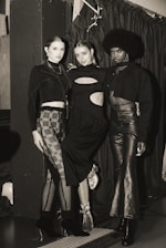 A diverse group of stylish individuals showcasing modern fashion in an urban setting.