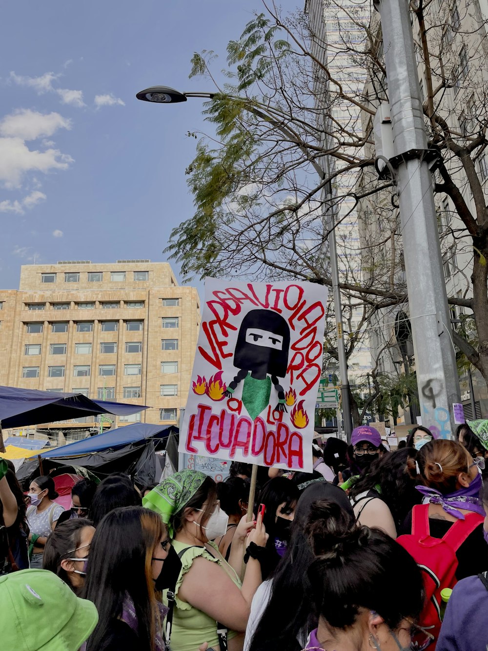 a crowd of people holding signs