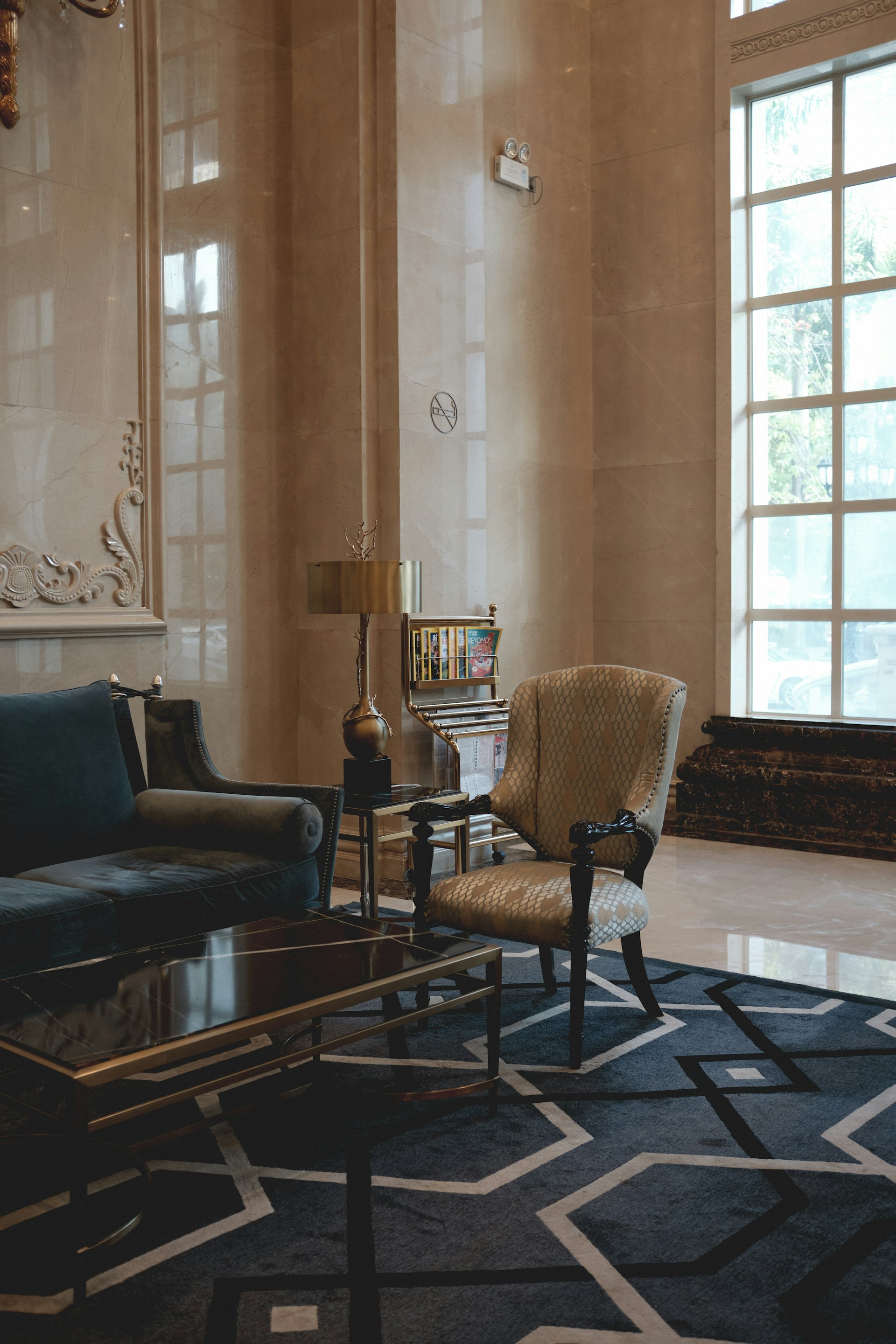 a living room with a rug and chairs