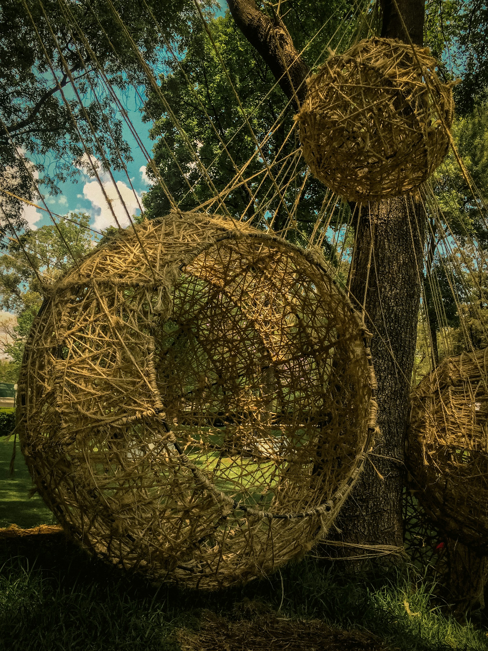 An outdoor installation of a large-scale kinetic sculpture interacting with natural light and shadows.