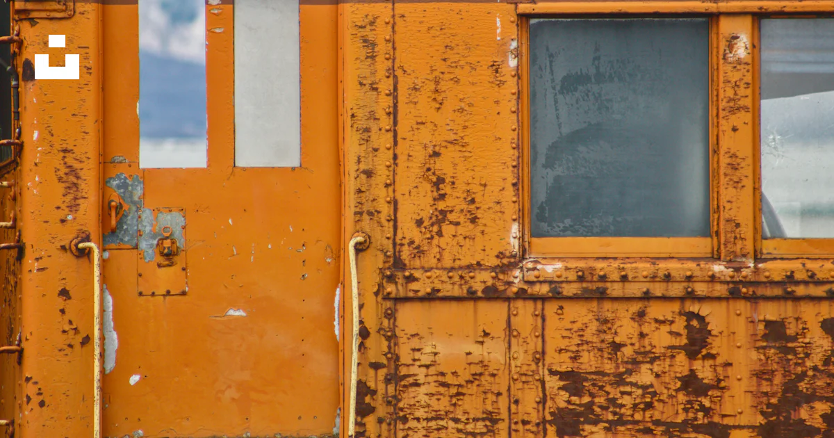 A rusted out building with broken windows photo – Free Brown Image on ...