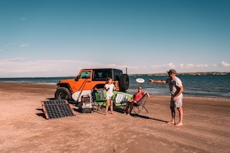 Family camping on beach with solar power bank