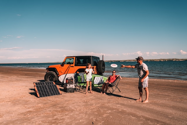 Family camping on beach with solar power bank