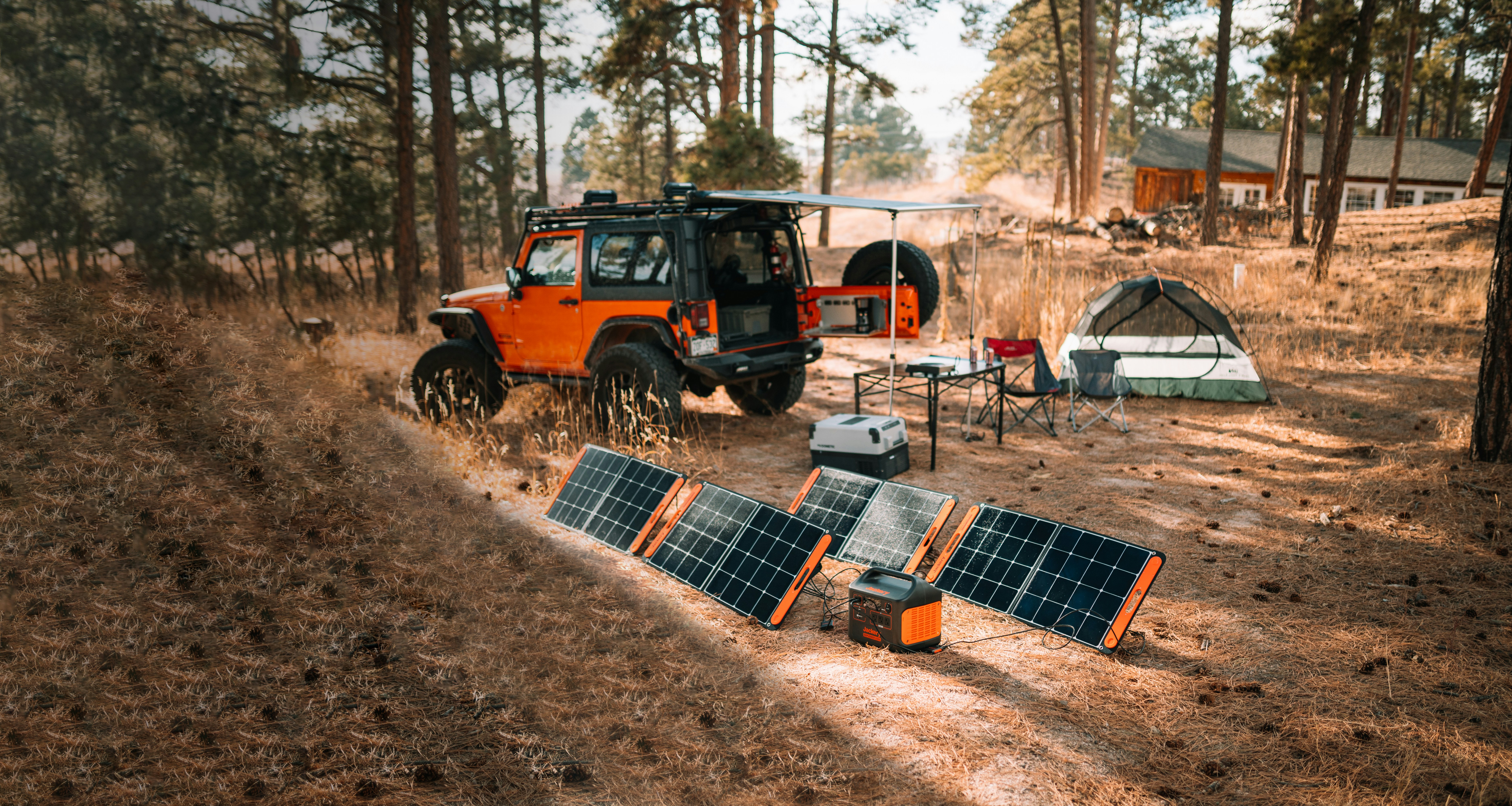 The Jackery 1000 power station charging via solar panels in an open field