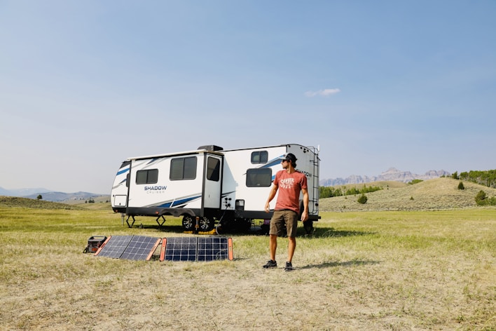 a person standing next to a solar power bank