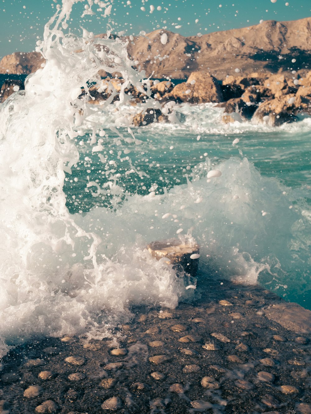 a wave crashing against a rock