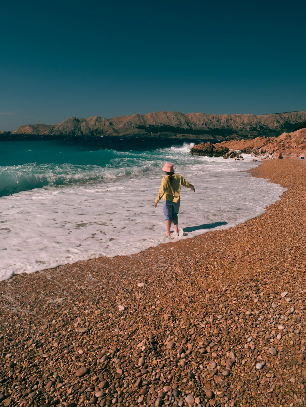 a child walking on a beach