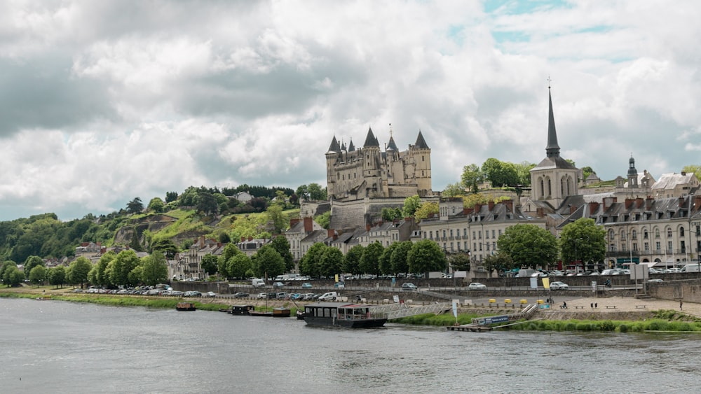 a castle on a hill by a river