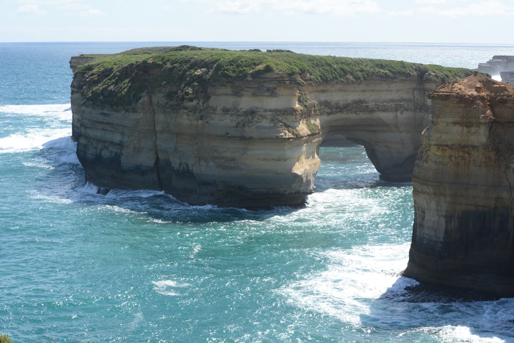 a cliff with a body of water below