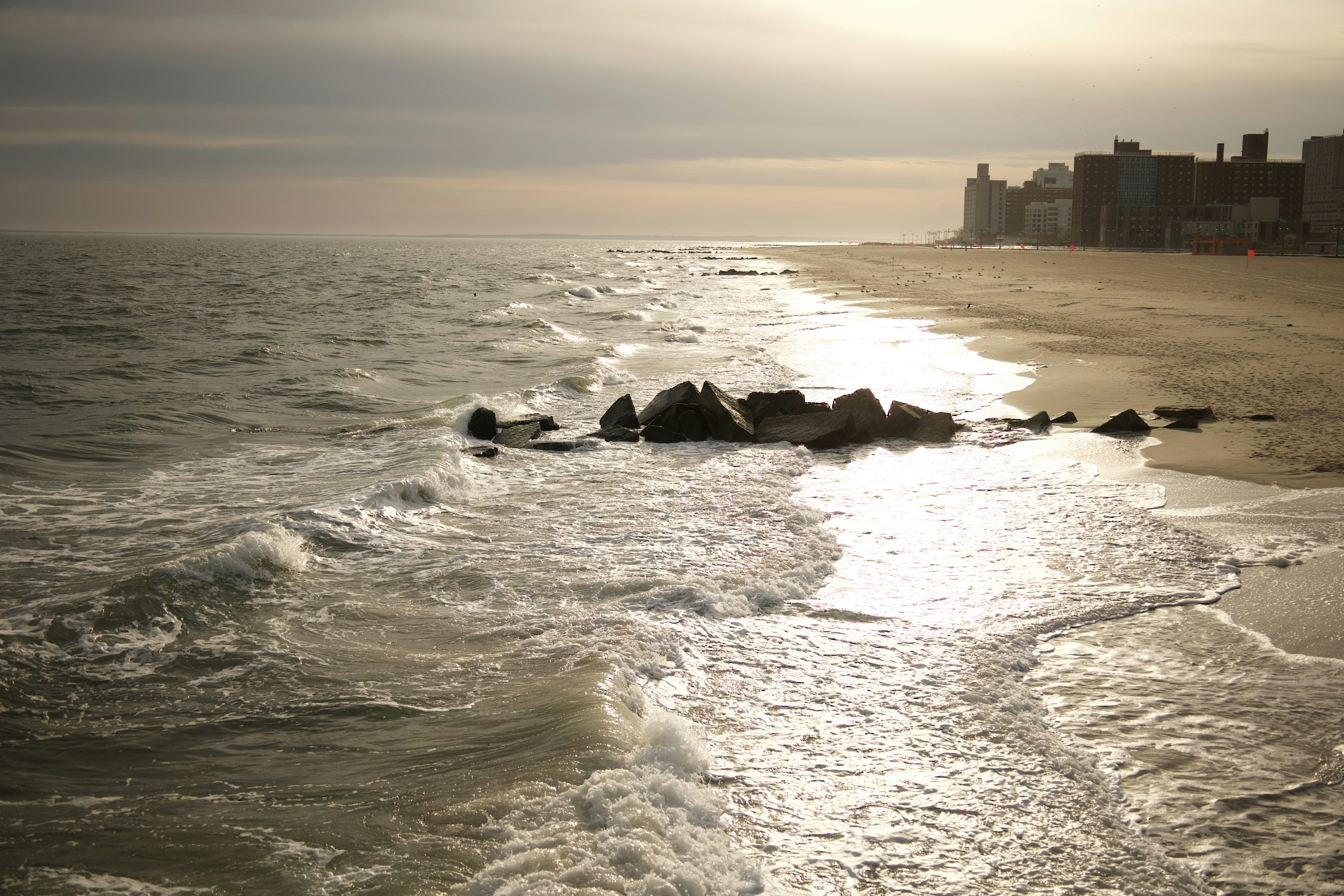 a beach with waves crashing on it
