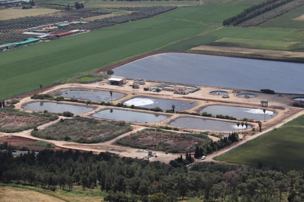 a large building with a pool in the middle of a field