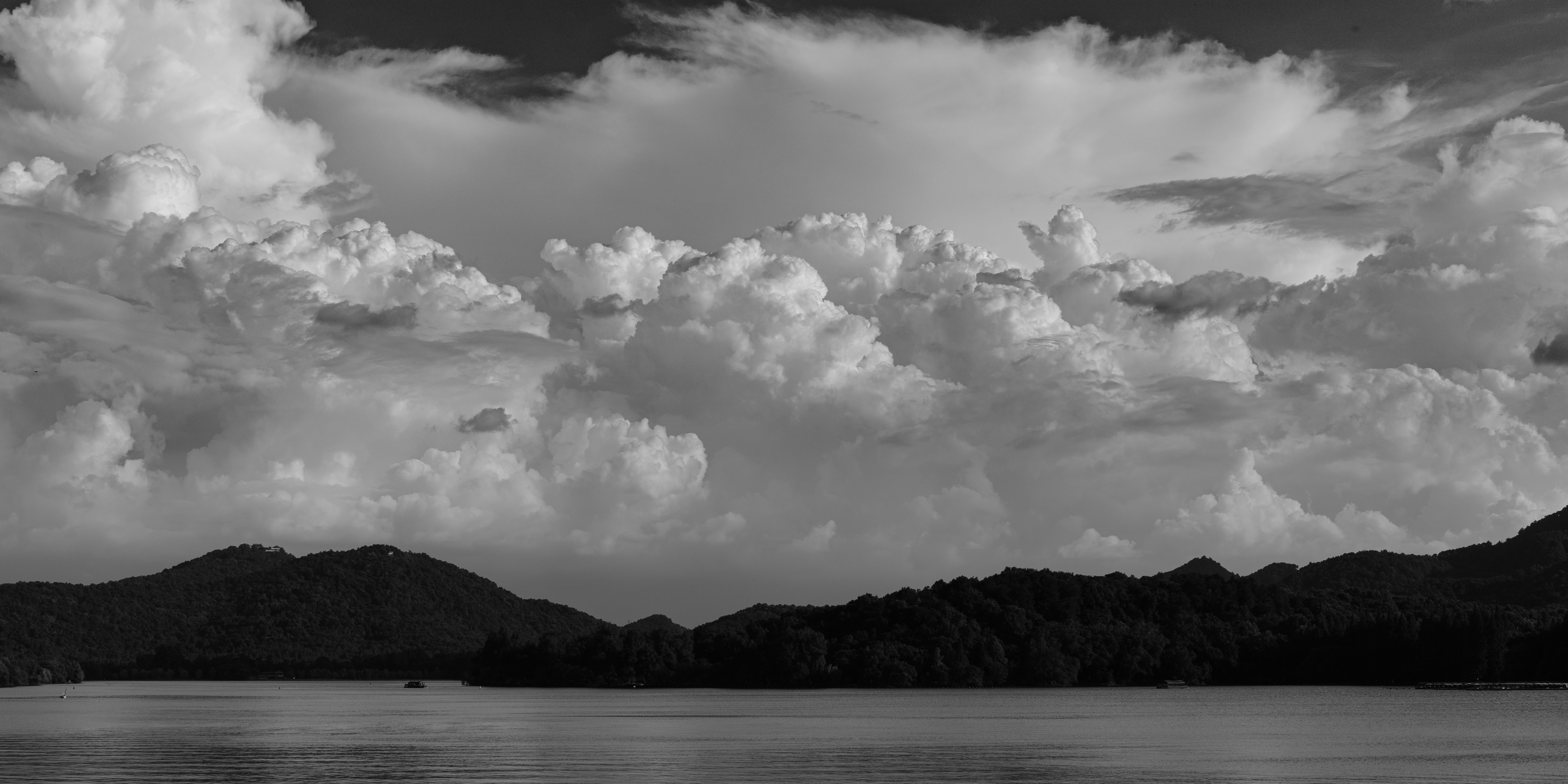 a body of water with mountains in the background