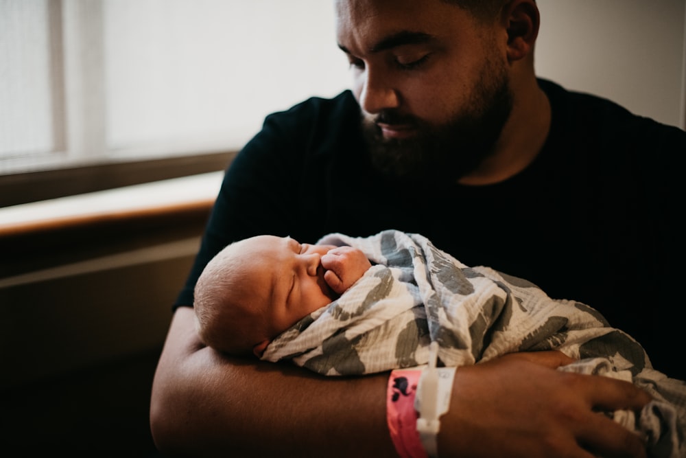 a man holding a baby