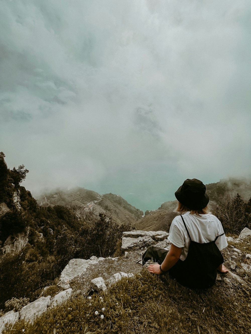 a person sitting on a rock