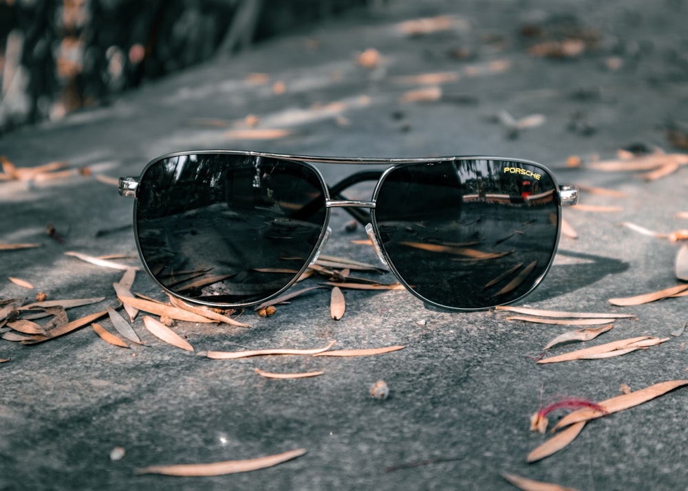 a pair of sunglasses on a concrete surface