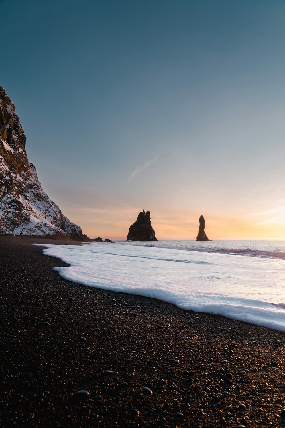 a beach with rocks and water