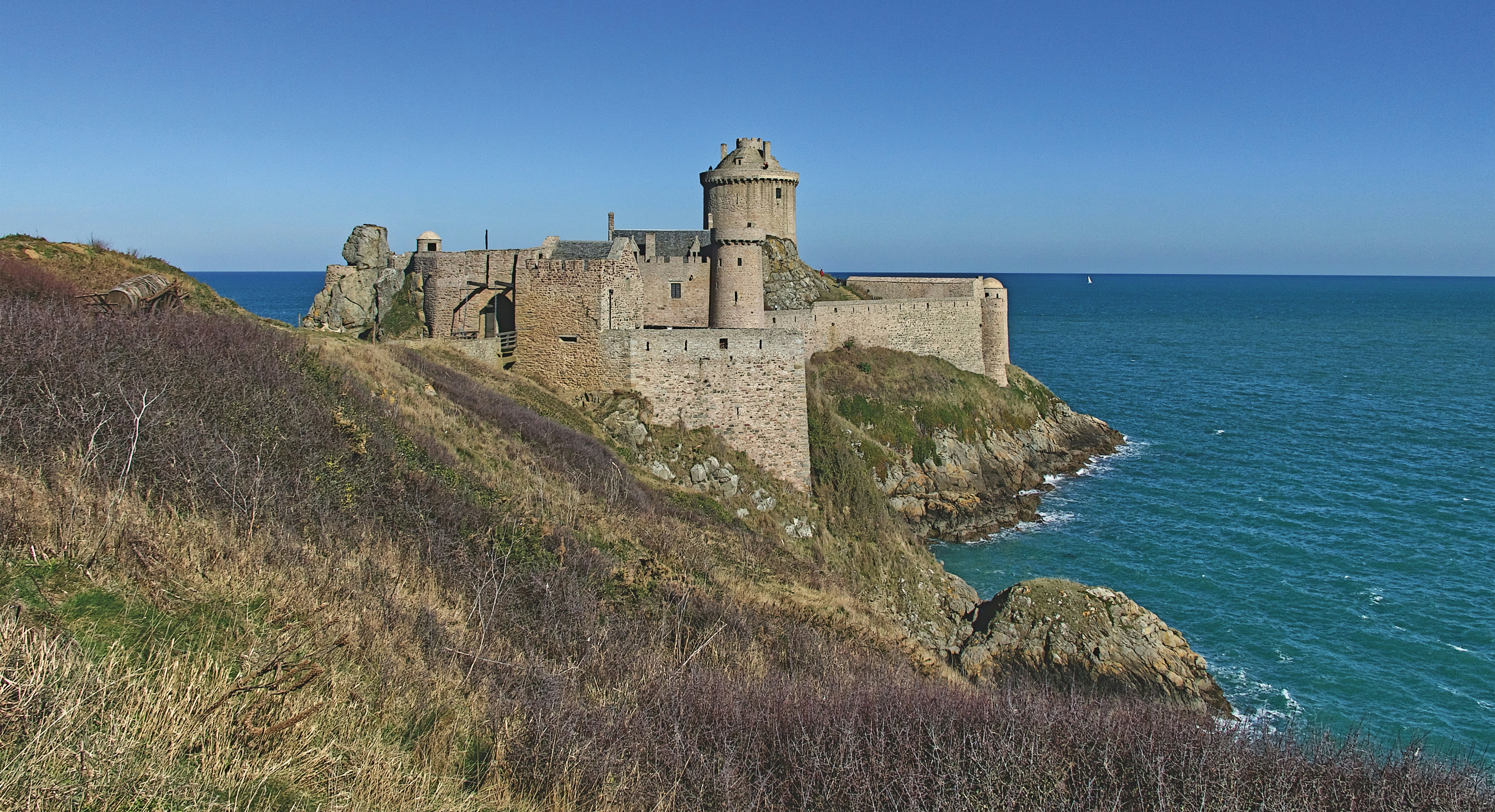 a castle on a cliff by the ocean