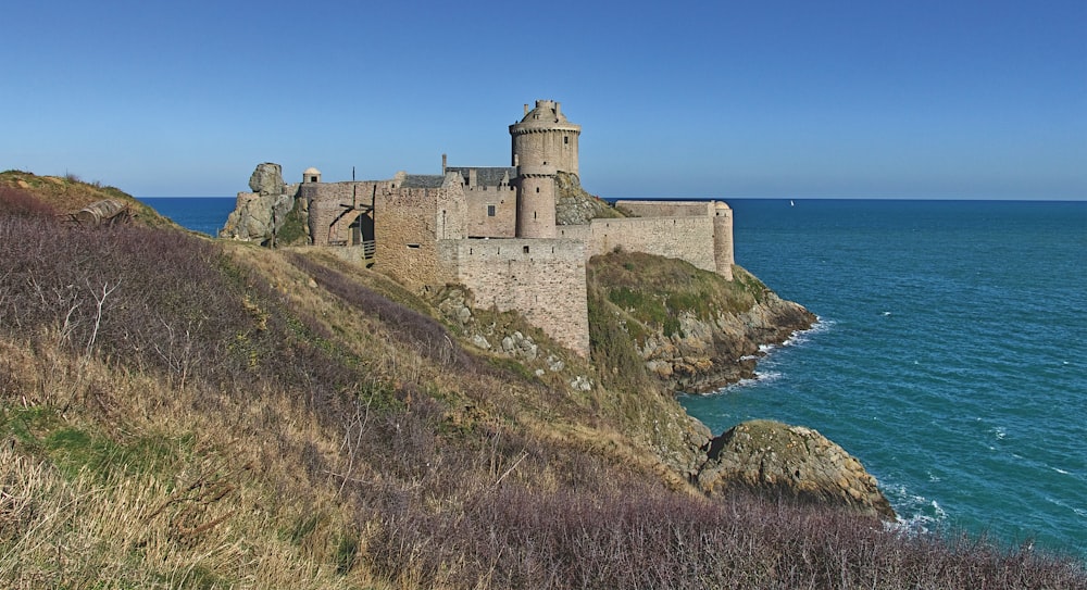 a castle on a cliff by the ocean
