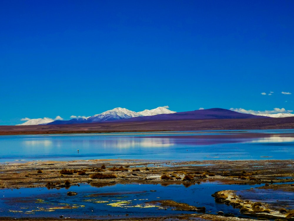 a body of water with a mountain in the background