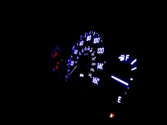 Close-up of a car dashboard with illuminated controls.