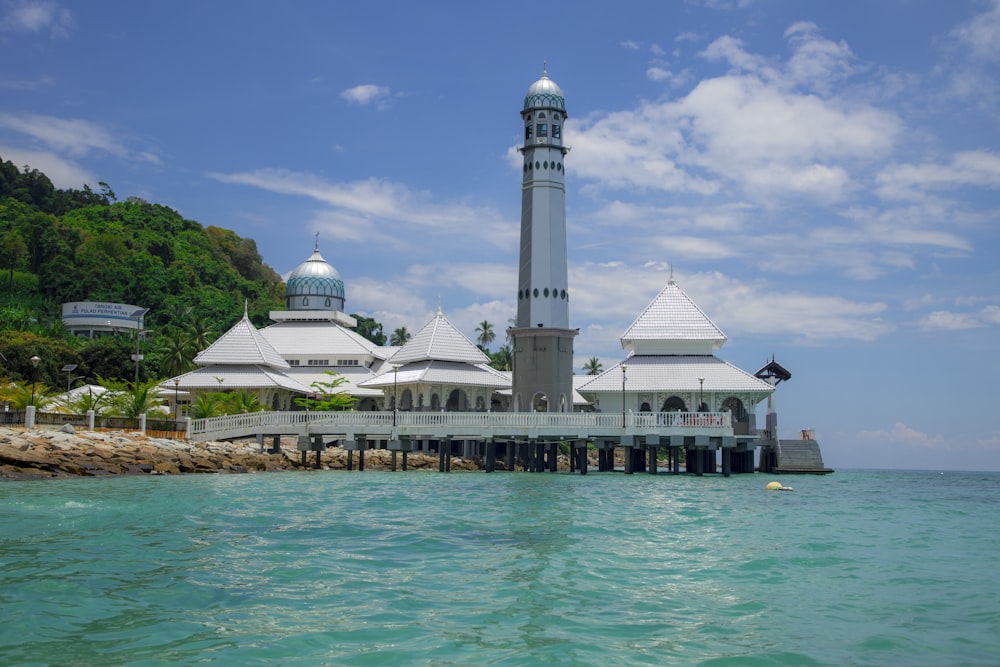 a white building with domed roofs by water