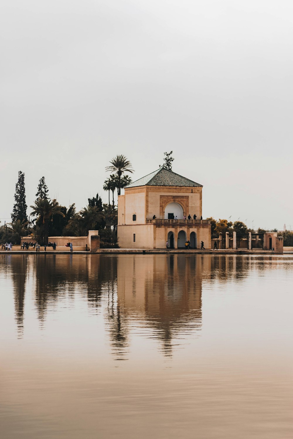 a building with a tower surrounded by water
