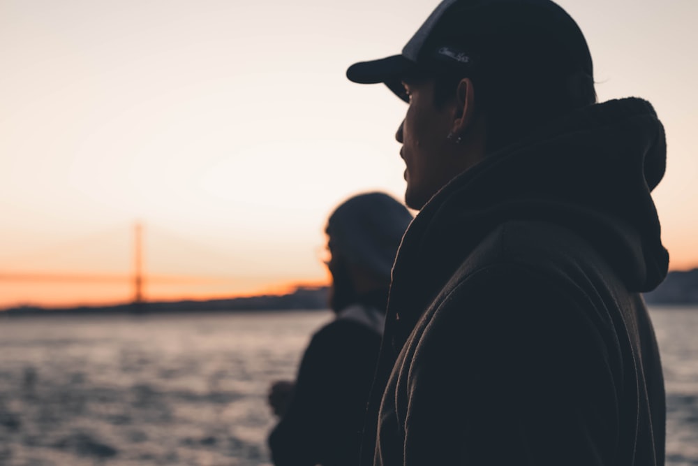 a woman and a man looking at the sunset