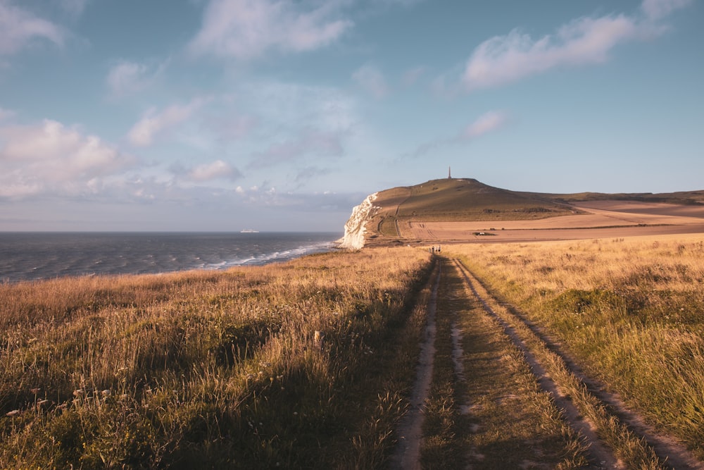 a dirt road leading to a beach