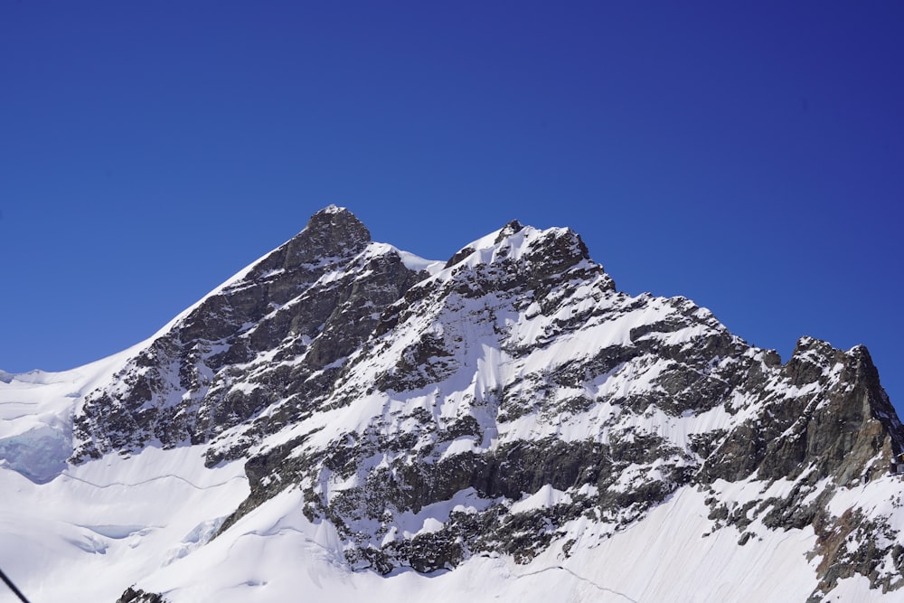 a snowy mountain with blue sky