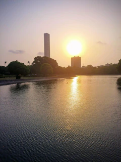 A serene sunset over the Lake Palace in Udaipur, reflecting golden hues on the water.