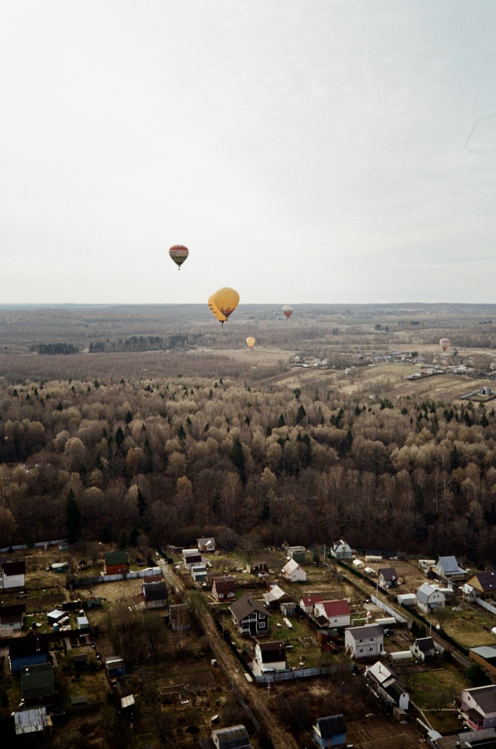 a group of hot air balloons over a city