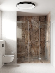 A spacious bathroom with a tub-to-walk-in shower conversion, highlighting sleek tile work and modern design.