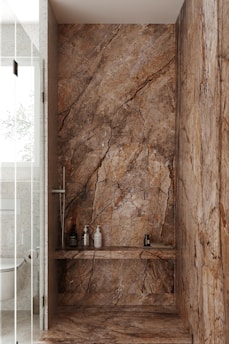 Close-up of a beautifully tiled shower with warm lighting highlighting the custom stonework.