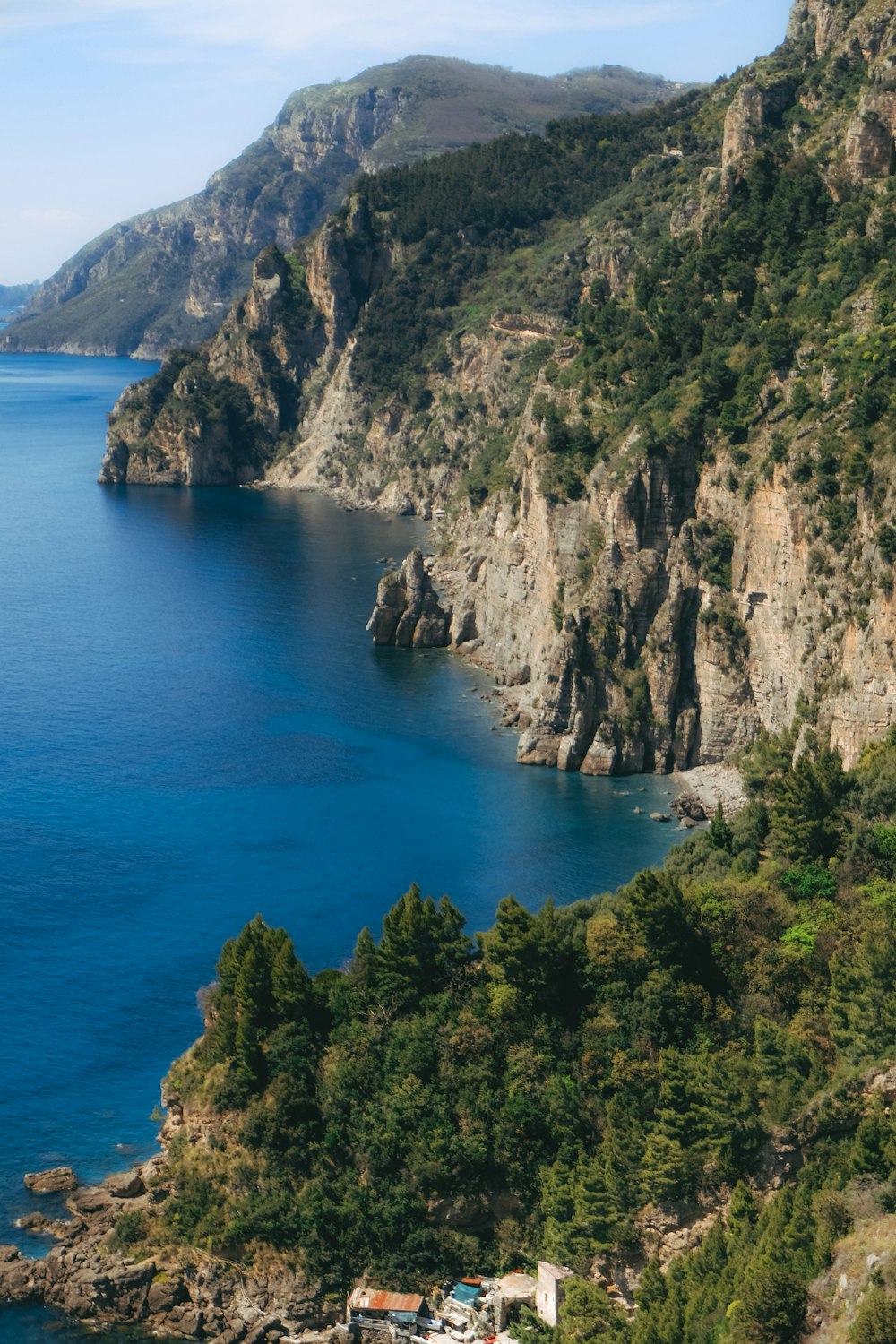 a cliff with houses and trees by it