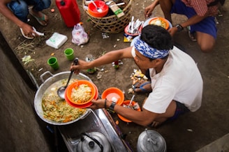 a man cooking food on a stove