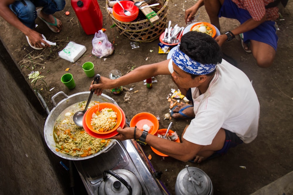 a man cooking food on a stove